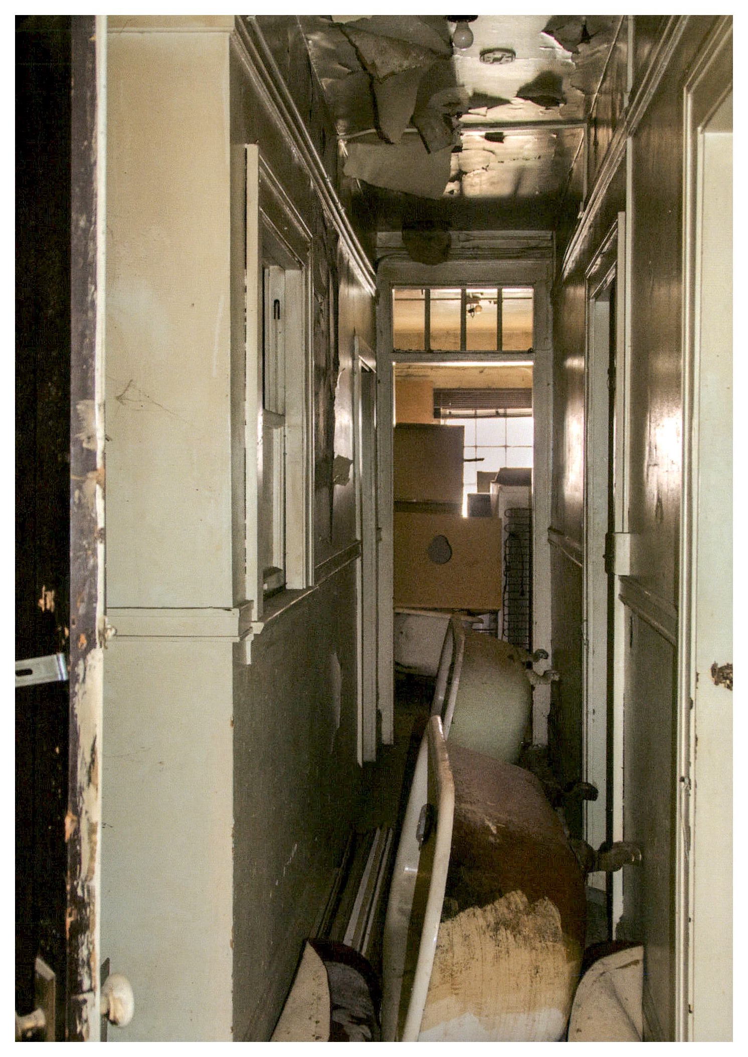 Before: view of typical narrow apartment hallway looking from hall entrance into unit.